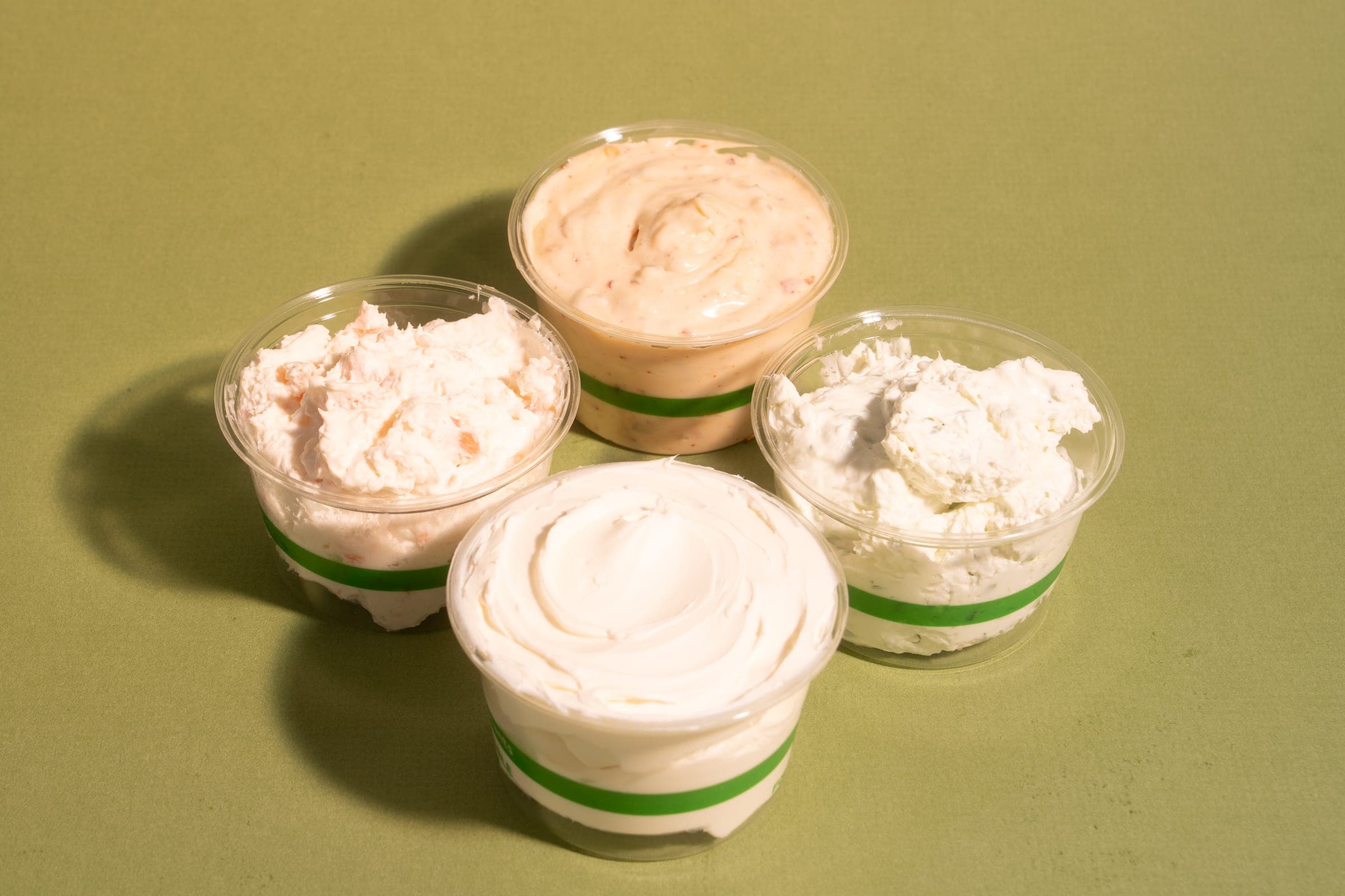 Four tubs of house-made cream cheese
